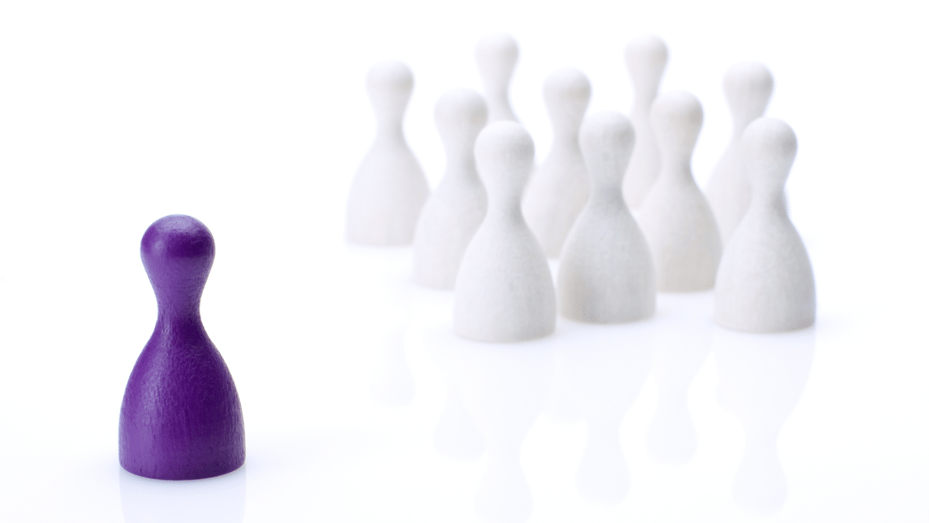 small purple toy in front of group of small white toys simulating leadership | how to find a great boss