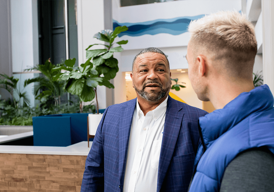 two men speaking in lobby