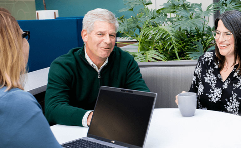 woman with laptop meeting with couple