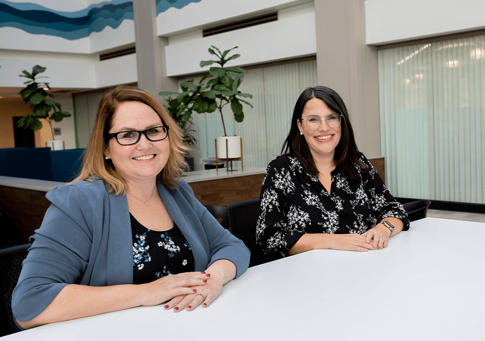 two professional women smiling