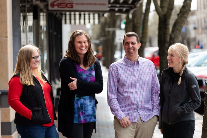 Blue & Co.'s Columbus Indiana employees laughing while walking down the streets of Columbus Indiana