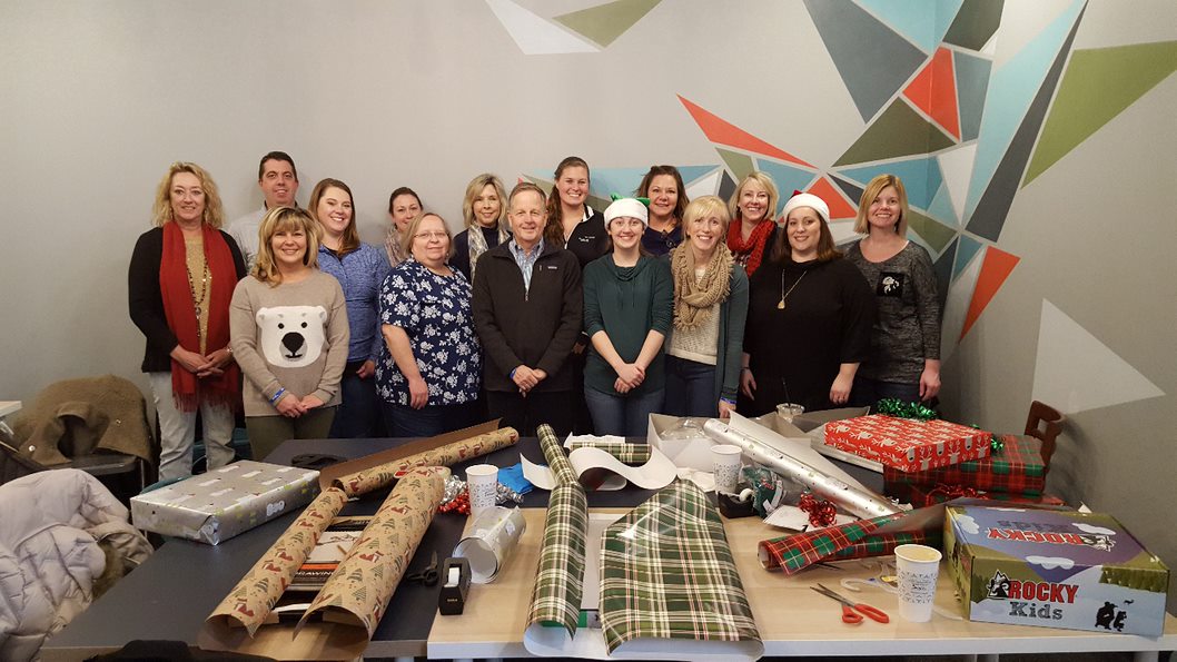 Staff from Columbus Indiana office wrap holiday presents together