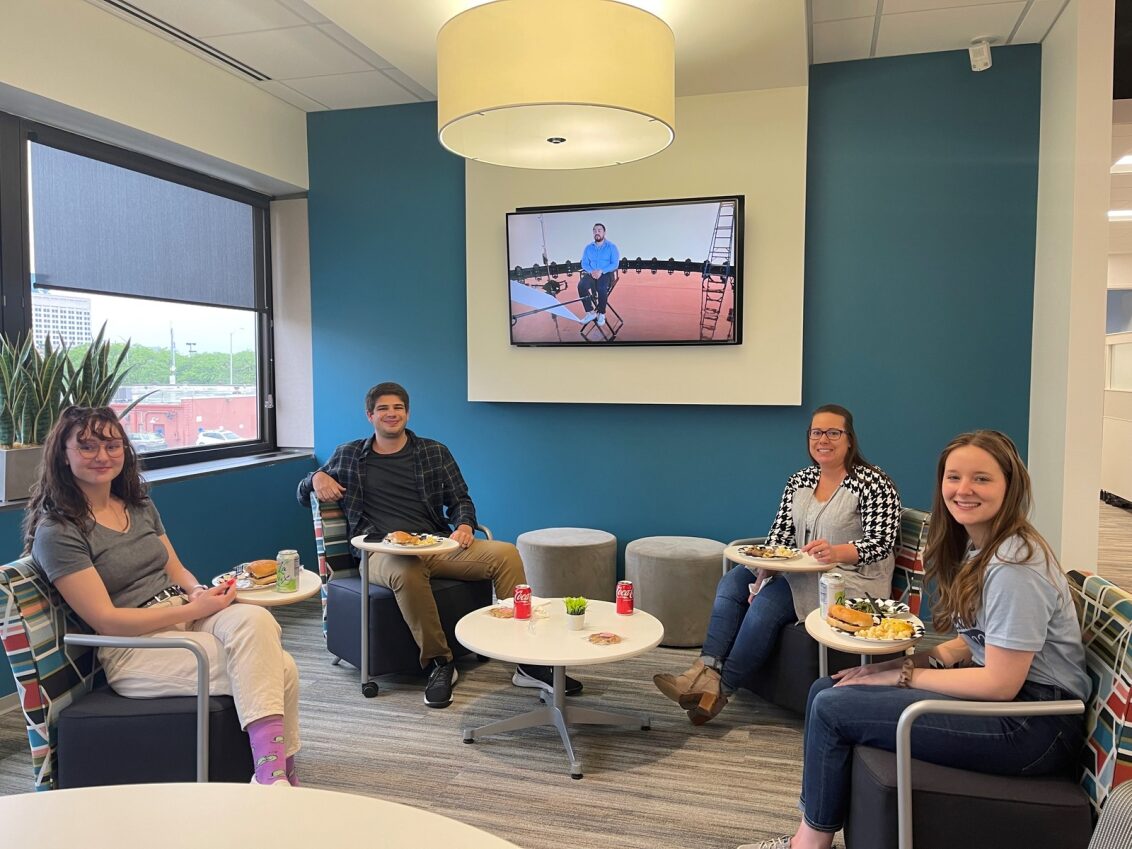 Four employees enjoy lunch in one of Indy's collaborative spaces