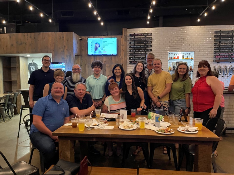 Lexington office team poses for a photo a Trivia Night