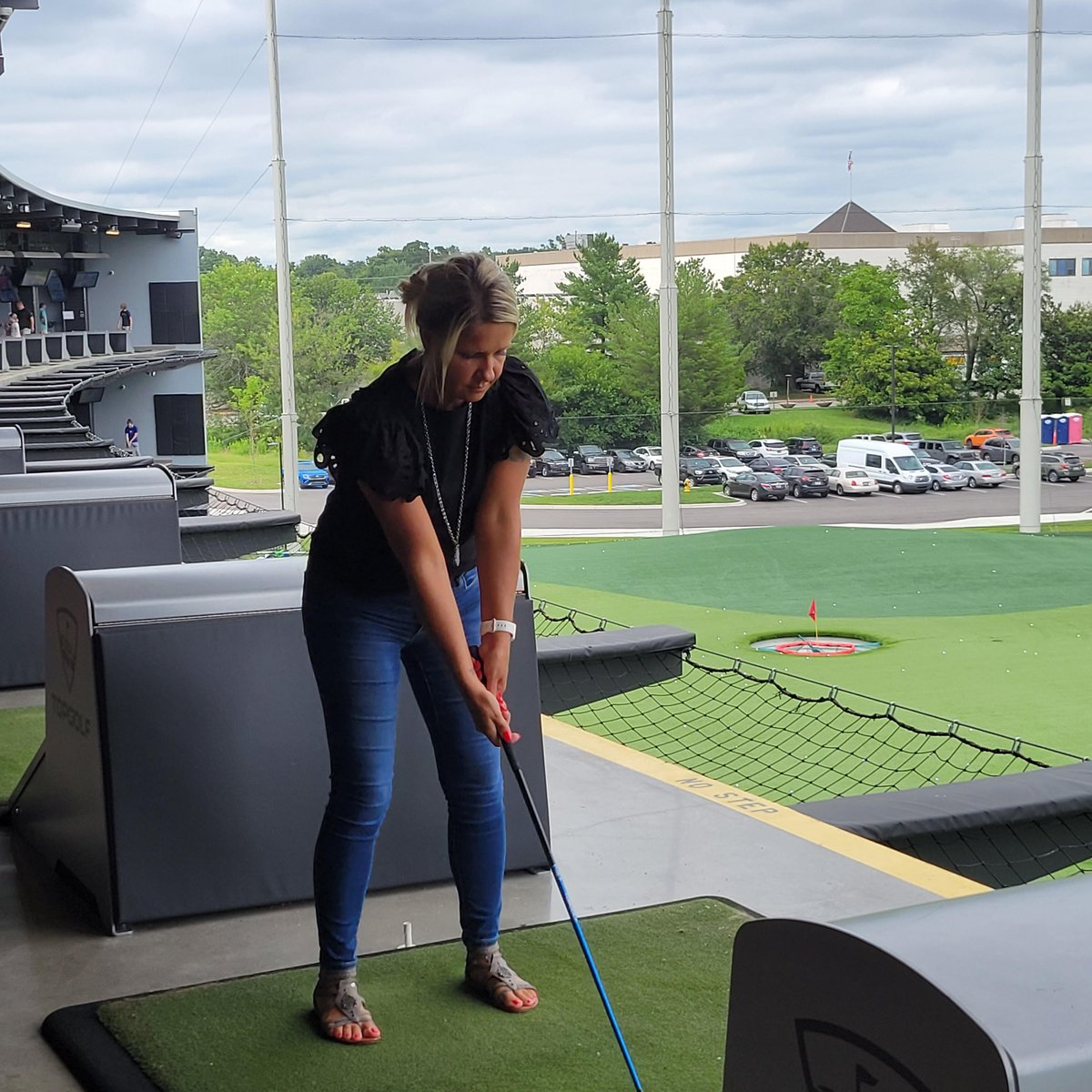 Louisville Firm Admin practicing their golf swing at TopGolf