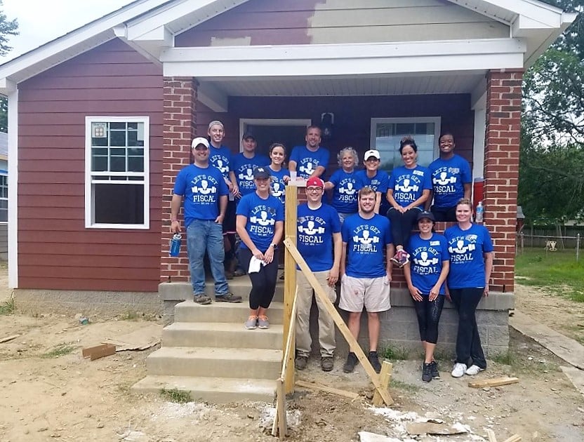 Louisville Kentucky employees smile for a photo during a community service day