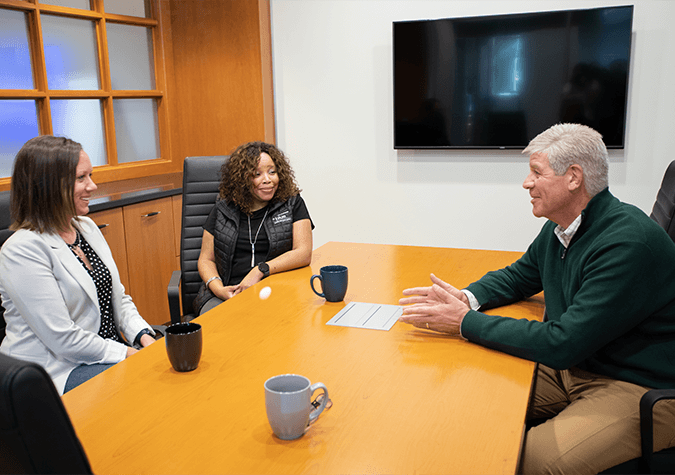 three people meeting in a conference room