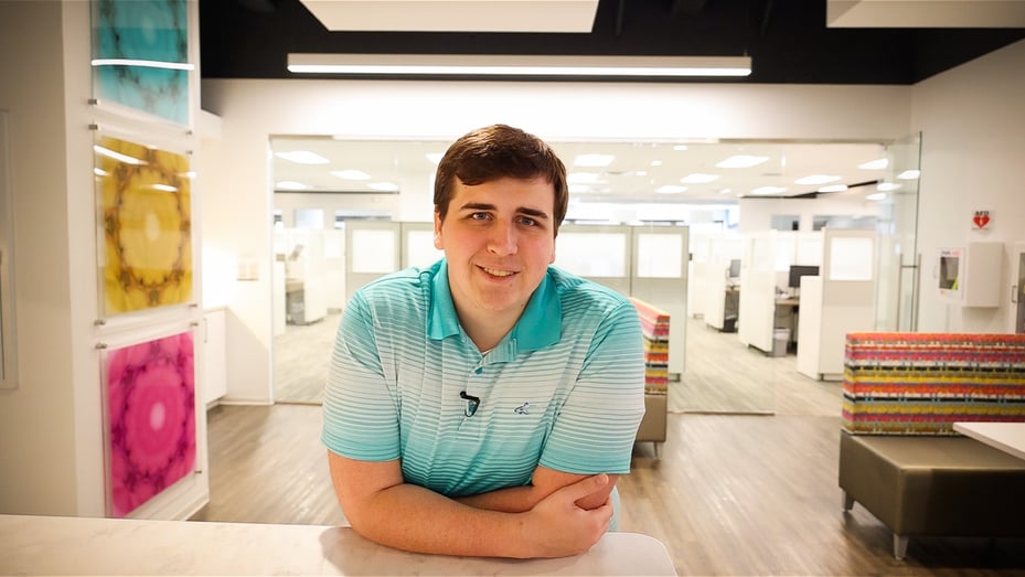 Blue Intern Tyler Hornaday poses in the Indianapolis office's kitchen break room